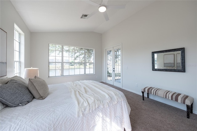 carpeted bedroom featuring french doors, lofted ceiling, access to exterior, and multiple windows