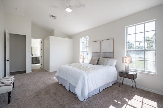 bedroom with lofted ceiling, multiple windows, light colored carpet, and ceiling fan