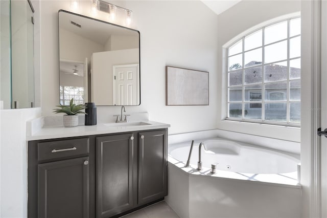 bathroom featuring vanity and a tub