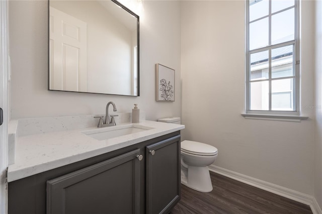 bathroom featuring vanity, hardwood / wood-style floors, and toilet