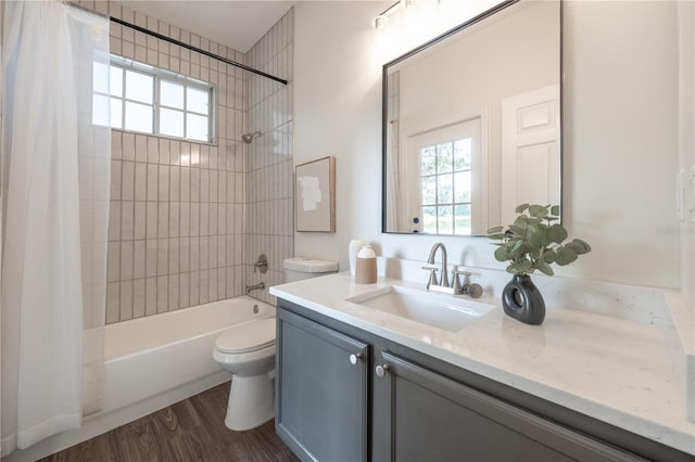 full bathroom featuring hardwood / wood-style flooring, vanity, toilet, and shower / bath combo with shower curtain