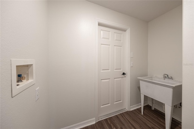 clothes washing area with dark hardwood / wood-style floors