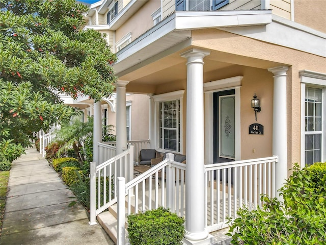 entrance to property featuring stucco siding and a porch