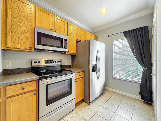 kitchen with stainless steel appliances, baseboards, ornamental molding, and light tile patterned flooring