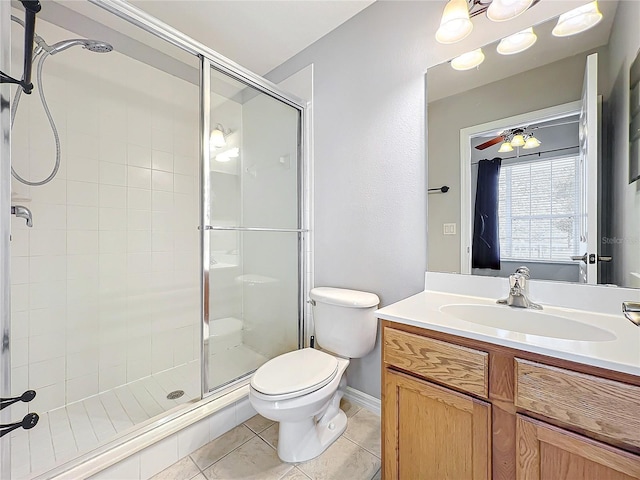 full bathroom featuring tile patterned floors, toilet, a stall shower, ceiling fan, and vanity