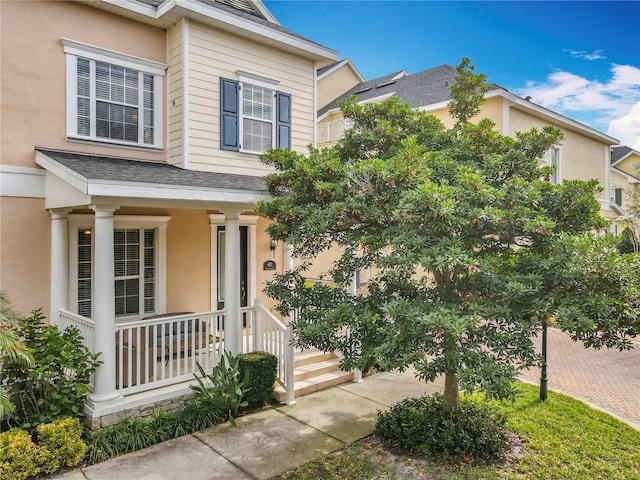 411 Old Farm Ln, Winter Springs, FL 32708 - traditional home with a porch, stucco siding, and roof with shingles