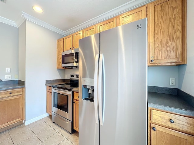 kitchen featuring dark countertops, baseboards, ornamental molding, light tile patterned floors, and stainless steel appliances