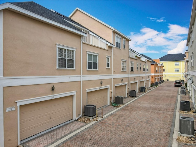 exterior space with central air condition unit and stucco siding