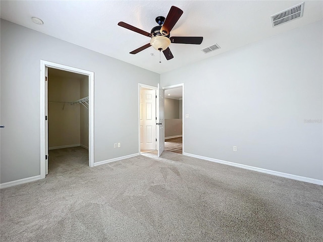 411 Old Farm Ln, Winter Springs, FL 32708 - unfurnished bedroom with baseboards, a spacious closet, carpet flooring, and visible vents