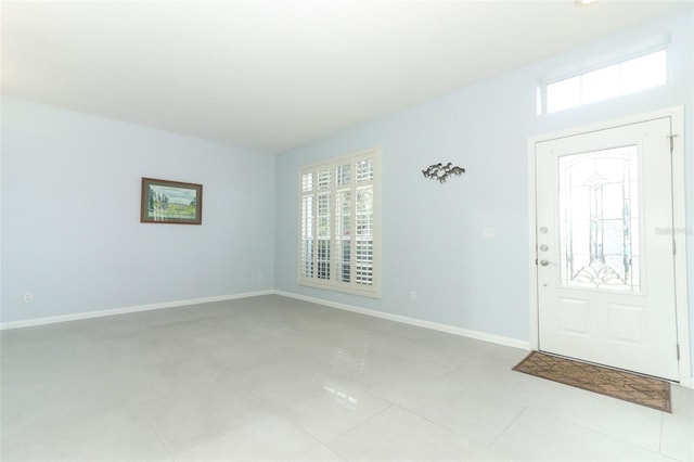 entrance foyer with baseboards and a healthy amount of sunlight