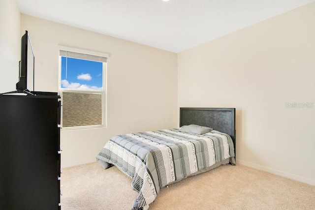 bedroom with light colored carpet