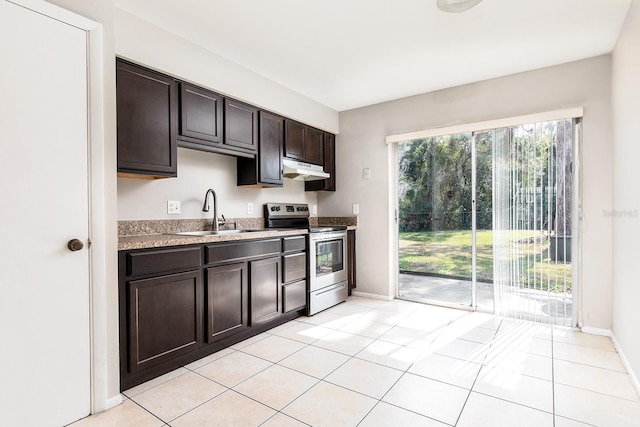 kitchen with electric stove, sink, light tile patterned floors, and dark brown cabinetry