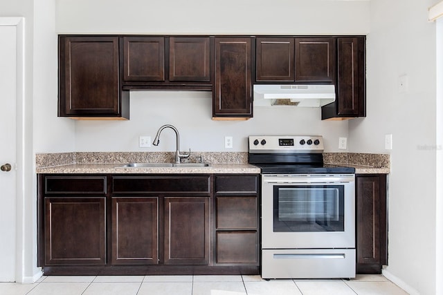 kitchen featuring electric stove, dark brown cabinetry, light tile patterned flooring, and sink