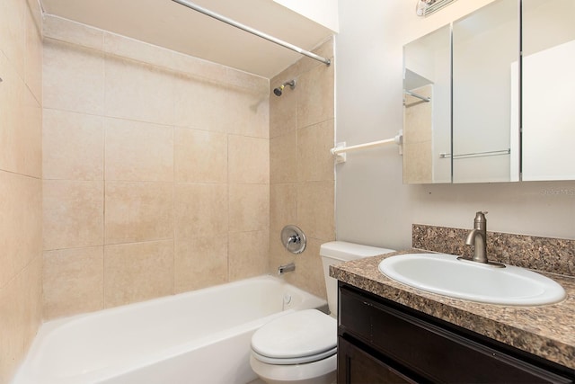 full bathroom with vanity, tiled shower / bath, and toilet