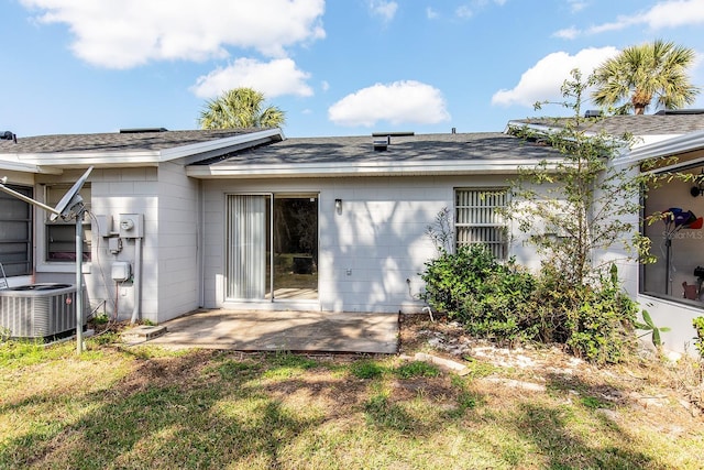 back of property with cooling unit, a yard, and a patio