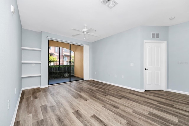 empty room with wood-type flooring and ceiling fan