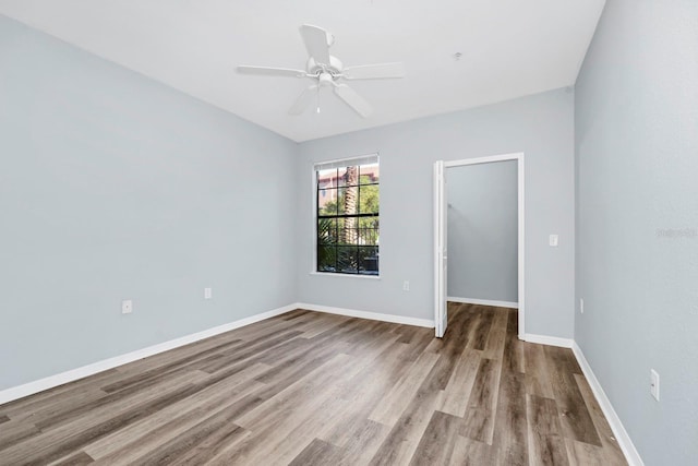 empty room with ceiling fan and light hardwood / wood-style floors