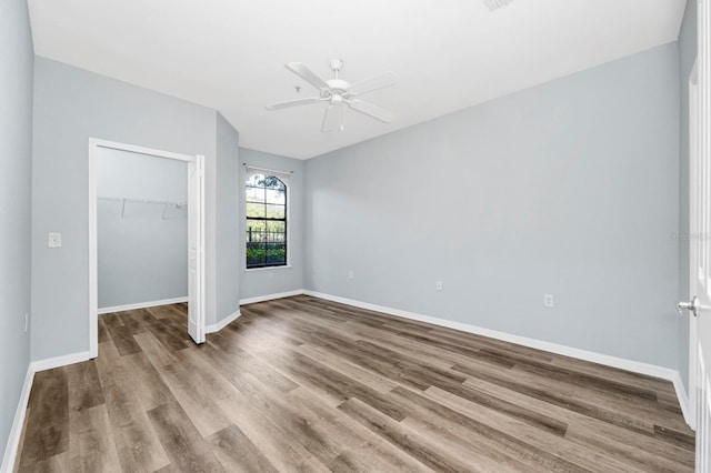 spare room featuring light hardwood / wood-style flooring and ceiling fan