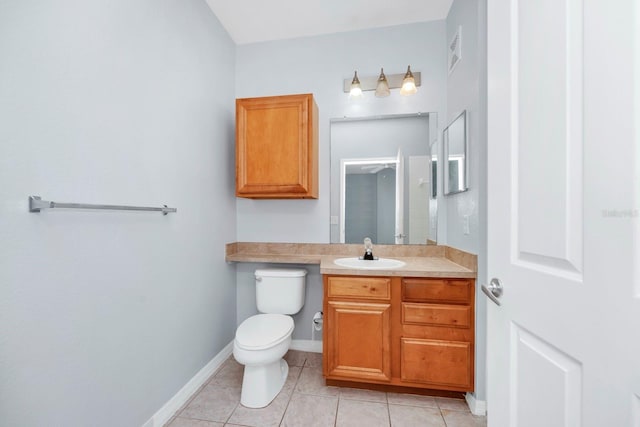 bathroom featuring vanity, tile patterned floors, and toilet