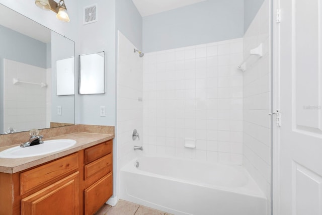 bathroom with tile patterned flooring, vanity, and tiled shower / bath combo