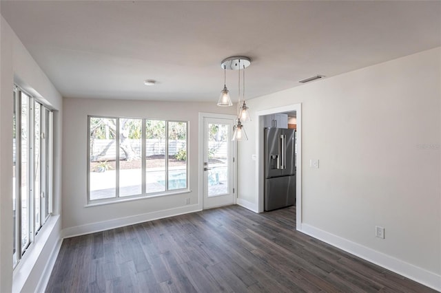 spare room featuring dark wood-type flooring