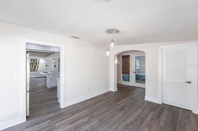 unfurnished room featuring dark wood-type flooring