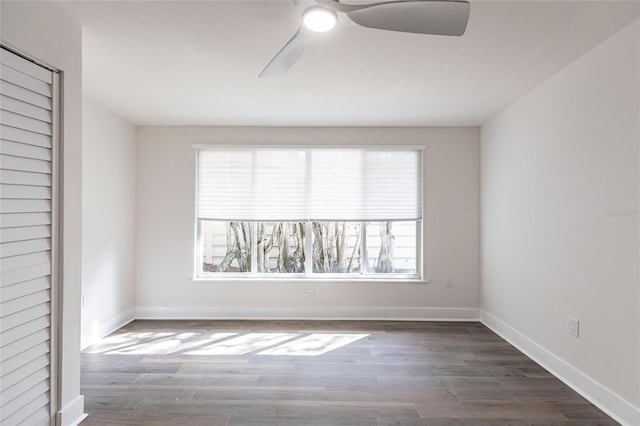 empty room featuring dark hardwood / wood-style floors and ceiling fan