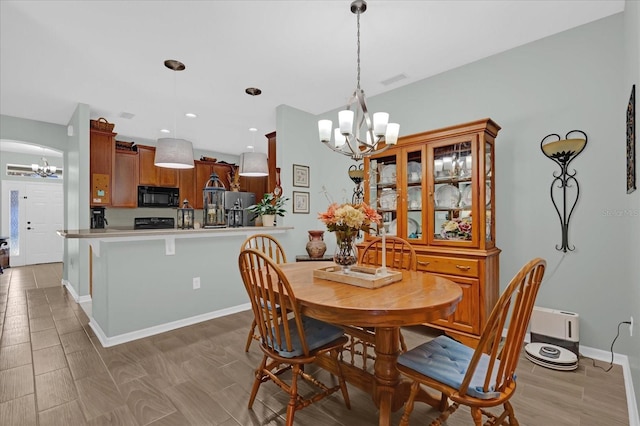 dining room with a notable chandelier and light hardwood / wood-style floors