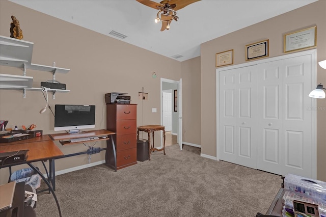 office space featuring light carpet and ceiling fan