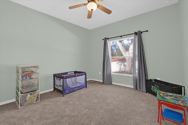 interior space with ceiling fan and light colored carpet