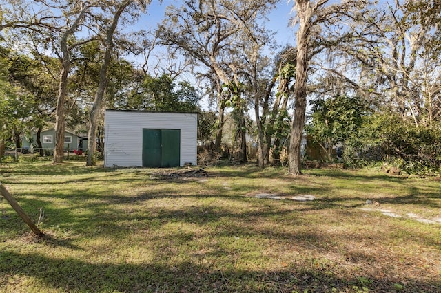 view of yard featuring a storage shed and an outbuilding