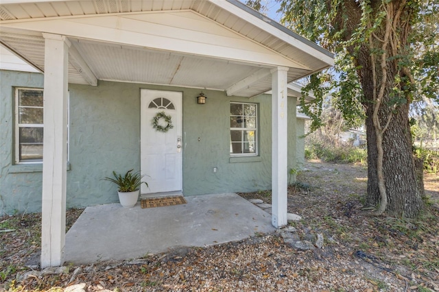 property entrance with stucco siding