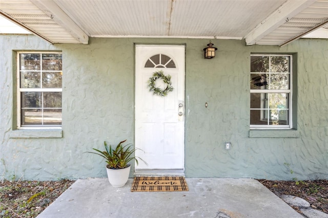 property entrance featuring stucco siding