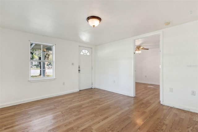 entrance foyer with light wood-style floors, baseboards, and a ceiling fan