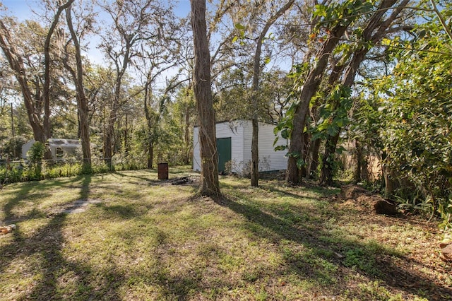 view of yard featuring fence and an outbuilding