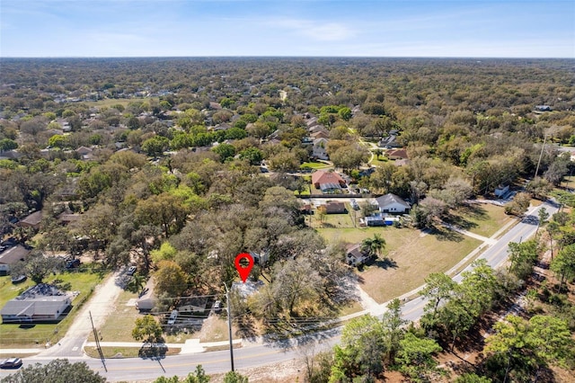 birds eye view of property with a forest view