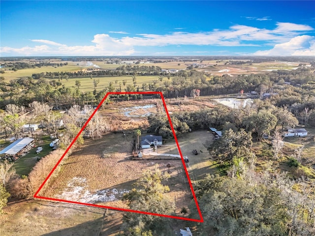 birds eye view of property with a rural view