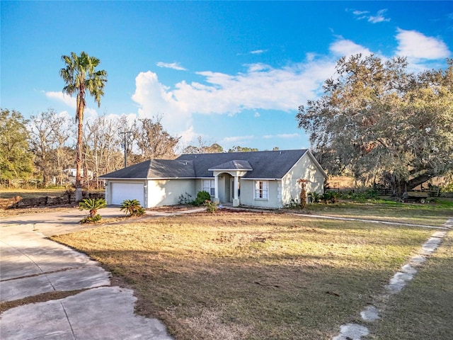 ranch-style house with a garage and a front lawn