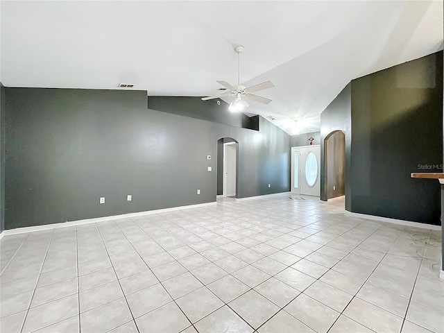 spare room featuring ceiling fan, vaulted ceiling, and light tile patterned floors