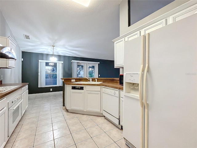 kitchen with light tile patterned flooring, pendant lighting, white cabinetry, sink, and white appliances