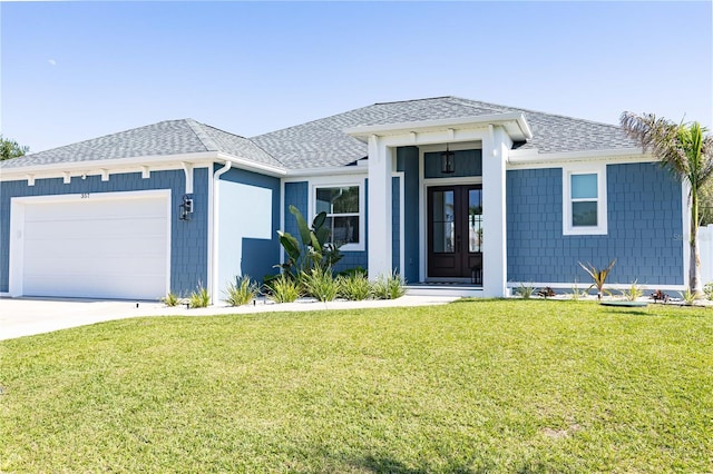 view of front of property featuring a garage and a front lawn