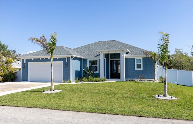 view of front of home with a garage and a front lawn