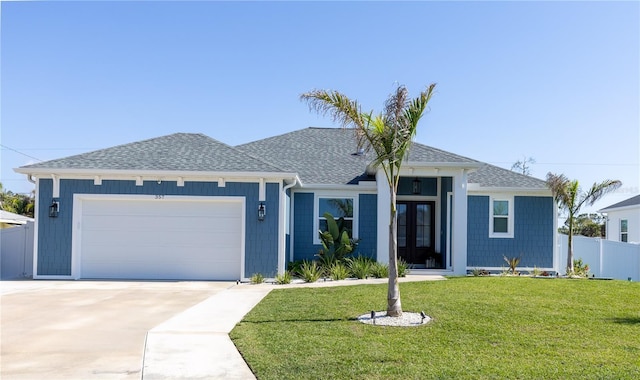 ranch-style home with a garage and a front yard