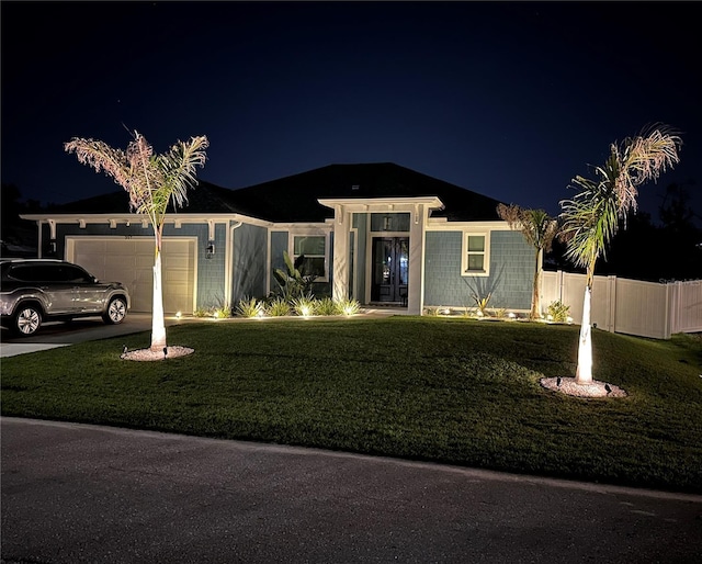 view of front facade with a garage and a lawn