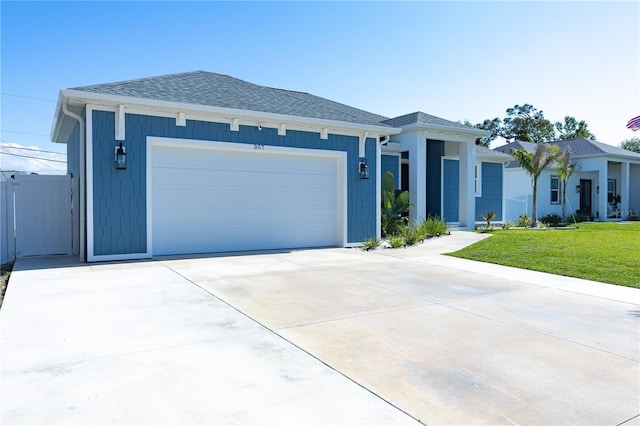 view of front facade with a garage and a front lawn