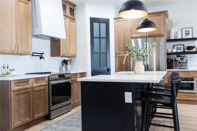 kitchen with pendant lighting, stainless steel appliances, a kitchen island with sink, and custom range hood