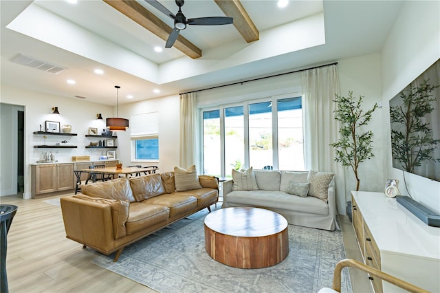 living room with beam ceiling, light hardwood / wood-style floors, and ceiling fan