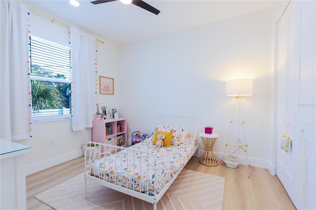 bedroom with ceiling fan and light wood-type flooring