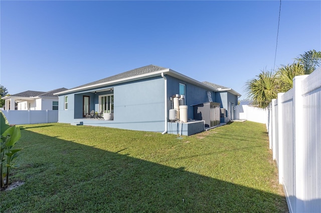 rear view of house with a lawn