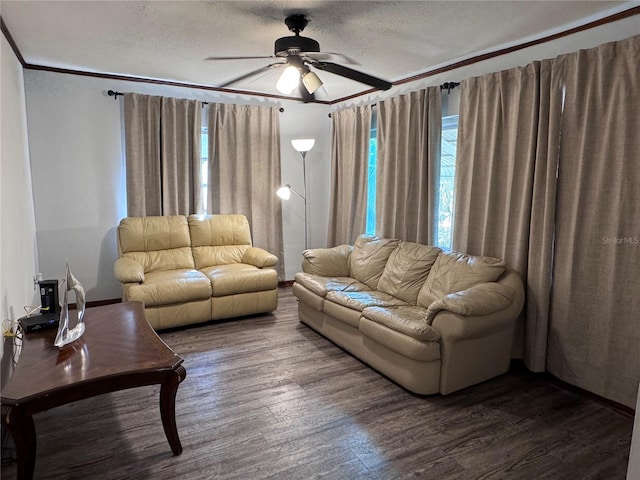 living room featuring hardwood / wood-style flooring, ceiling fan, ornamental molding, and a textured ceiling